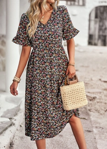 Chic floral V-neck short sleeve dress with A-line waist shown on a European street