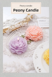 Detailed view of layered peony candles in purple, pink and yellow on lace cloth