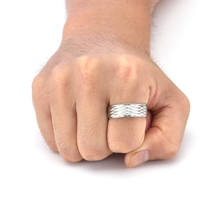 Detail of men's titanium steel ring with geometric diamond pattern texture on hand