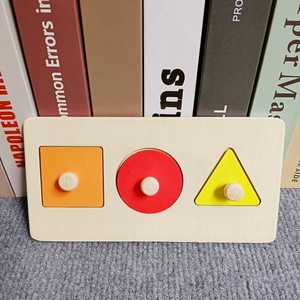 Detail of wooden Montessori geometric puzzles with handles for toddlers to practice shapes