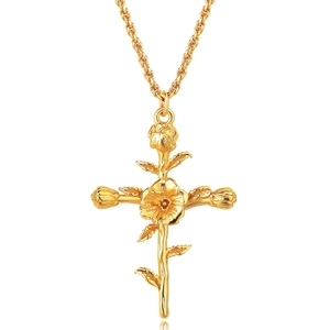 Close-up of gold flower cross necklace with intricate rose pendant and twisted rope chain