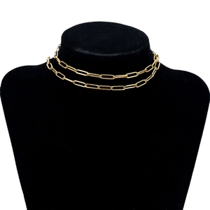 Golden titanium steel paperclip chain necklace displayed on a black neck model