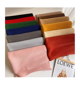 Macro shot showing pleated fabric texture and twelve color options for long scarves