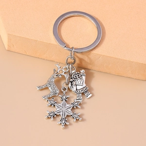 Detail of vintage silver keychain with Santa Claus, reindeer, and snowflake charms