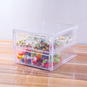 Close-up of clear acrylic double-layer drawer organizer storing colorful beads and hair clips