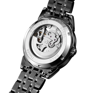 Macro view of automatic mechanical watch movement through the stainless steel exhibition caseback
