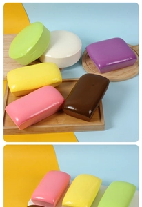 Close-up of assorted colorful PU slow rebound bread toys on a wooden display tray