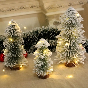 Three snowy cedar table Christmas trees with warm LED lights and wooden base decor