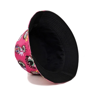Reversible rose red bucket hat with colorful eye graffiti pattern and black inner lining