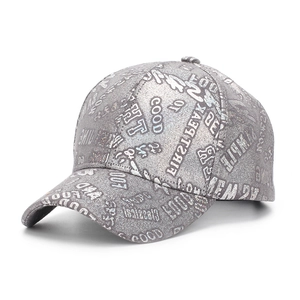 Detail of silver glitter baseball cap with GOOD and FIRSTPEAK embroidered text
