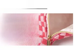 Macro shot of smooth gold metal zipper and checkered fabric texture on the sports waist bag
