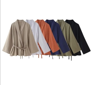 Flat lay of linen-textured wrap jackets in beige, white, orange, navy, olive, and black