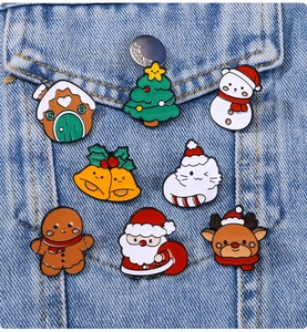 Detailed set of eight festive Christmas enamel pins featuring Santa and snowman on denim