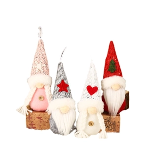 Set of four knitted Christmas gnomes with snowflake and heart motifs for tree decoration