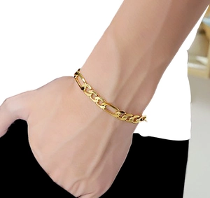 Close-up of 18K gold plated stainless steel Figaro chain bracelet worn on a male wrist