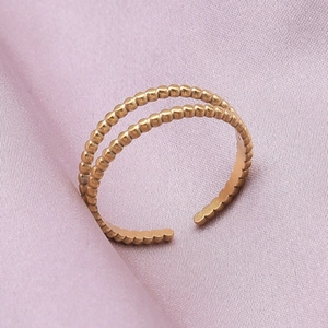 Detailed macro shot of golden double-layer beaded texture adjustable open ring