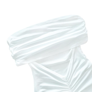 Close-up of white off-the-shoulder dress featuring ruched chest and V-shaped seam detail