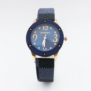 Detailed view of vintage blue leather strap watch with gold case and woven texture