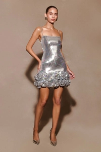 Detailed view of silver sequin cocktail dress with 3D floral hem and metallic finish