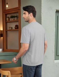 Macro shot of light gray men's T-shirt showing detailed vertical knit fabric texture