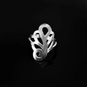 Detailed view of hollow floral vine pattern on a polished silver stainless steel ring