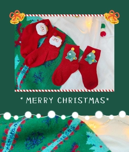 Detail view of festive cotton Christmas socks featuring 3D Santa and tree decorations