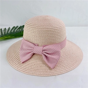 Summer straw sun hat for women with pink ribbon bow on white background