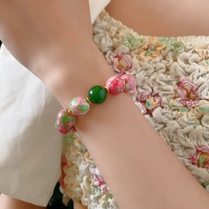 Detail of floral ceramic beads and gold plating on an elegant beaded bracelet