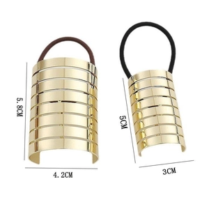 Golden minimalist metal hair rings with stripe texture in two sizes for ponytail styling