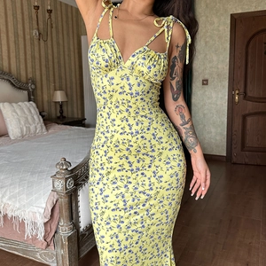 Detail of yellow floral dress showing adjustable straps and ruched bust design