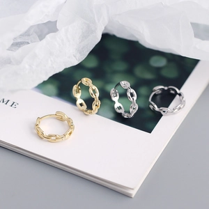 Set of four minimalist silver and gold link chain hoop earrings on a white display card