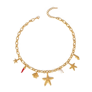 Flat lay of gold ocean charms necklace with starfish shell and pearl on white background