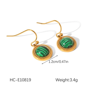 Detail of vintage gold earrings with green malachite stone and beaded metal edges