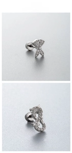 Detailed view of silver butterfly and dragon earrings with cubic zirconia and screw backs