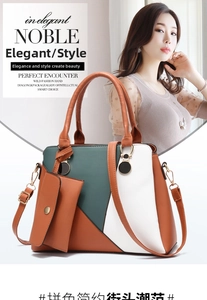 Macro detail of the color-block tote bag with gold hardware and removable strap