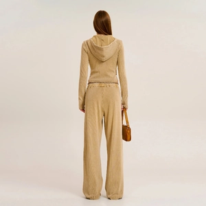 Detail of khaki waffle knit texture and loose fit on retro style casual sports pants