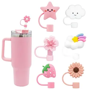 Pink tumbler set with decorative silicone straw toppers in flower and cloud shapes
