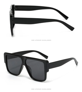 Detail view of large square black frame sunglasses with a polished finish and sleek temples