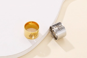 Detailed macro view of laser-cut Tree of Life patterns on gold and silver polished rings