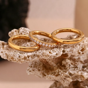 Detailed macro view of 18K gold plated ring set with sparkling zircons on natural rock