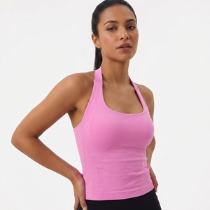 Detailed view of pink halter neck sports bra with breathable seamless knit texture