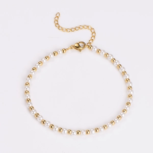 Detail of vintage pearl bracelet with gold beads, lobster clasp and adjustable chain