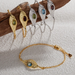 Leaf design S925 silver bracelets with colorful gemstones on a wooden display stand
