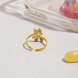 Detailed view of 18k gold plated flower ring on white sand with summer aesthetic vibe
