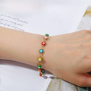 Colorful Evil Eye charm bracelet in 18K gold plated stainless steel on female wrist