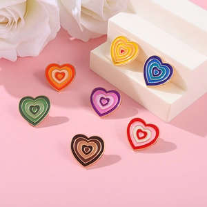 Detail showing multi-colored Y2K gradient heart brooches with gold plating and enamel finish