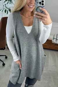 Mirror selfie showing dark grey V-neck knit vest with side pockets and casual fit
