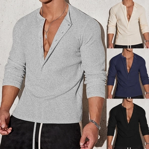 Detail of slim fit waffle knit Henley shirt showing textured fabric and buttoned V-neckline