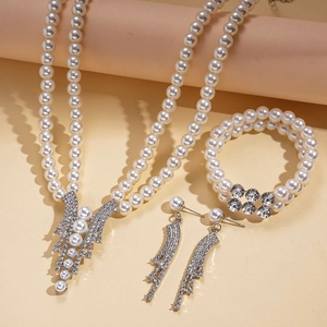 Three-piece pearl and rhinestone jewelry set with layered necklace, bracelet and earrings