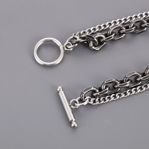 Detail of silver dual-layer Cuban chain bracelet with OT buckle and vintage finish